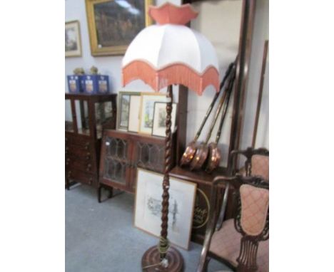 An oak barley twist standard lamp