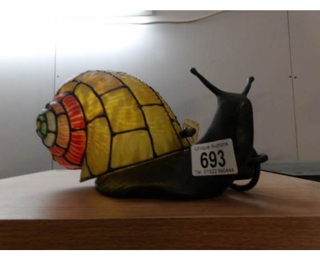 A bronzed cast iron Tiffany style table lamp as a snail