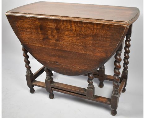 A Mid 20th Century Oak Barley Twist Oval Topped Drop Leaf Gate Legged Dining Table 