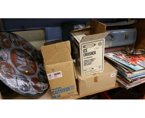 Shelf of assorted clock, records, ice crusher etc.