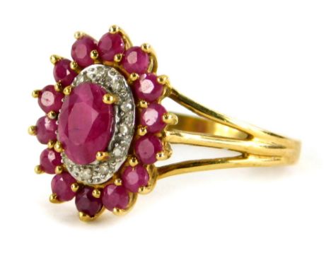 A floral cluster dress ring, set with various rubies and tiny diamonds, on a three row split design shoulder, yellow metal st