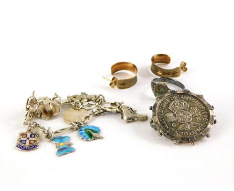 A small group of jewellery, comprising a pair of silver gilt hoop earrings, a George IV coin brooch, a silver charm bracelet 