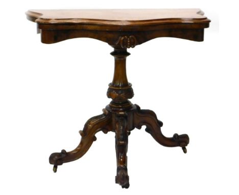 A Victorian walnut and burr walnut card table, the serpentine shaped top with a moulded edge on a turned and carved column, a