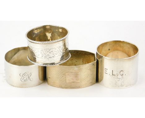 Four silver napkin rings, to include one with engine turned decoration and a vacant cartouche, 3½oz.