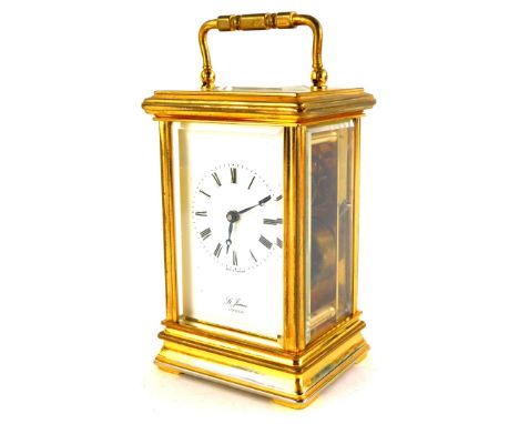 A St James brass carriage clock, with enamel type dial and loop handle, 15cm high.