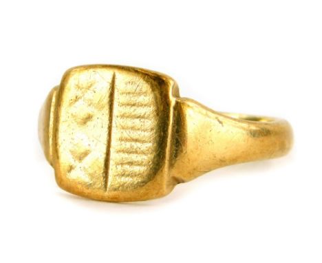 A 9ct gold signet ring, with a rectangular shield, rubbed etched decoration, stripes to one side, two crosses to the other, r
