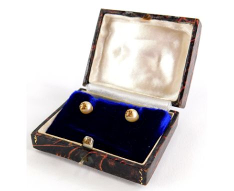 A pair of cultured pearl earrings, each with single pearl and gold six point flower end, on screw on butterfly backs, yellow 