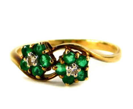 A 9ct gold dress ring, set with two flower designs, each with emerald and tiny diamond, on twist decoration, ring size O½, 1.