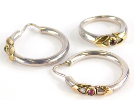 A ring and earring set, the ring on white metal band with yellow metal V shoulders and a central garnet in rub over setting, 