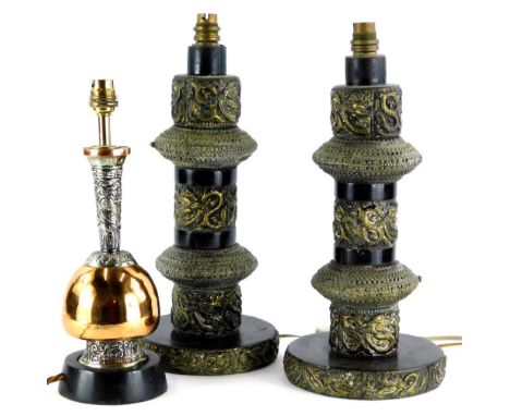 A pair of Indian brass table lamps, each modelled with scrolls, 'S' shaped motifs, and applied with bangles, 41cm high overal