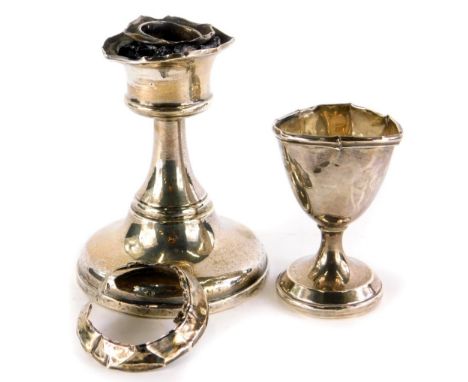 A George V silver squat candlestick, with loaded base, Birmingham 1919, 10cm high, and a silver egg cup engraved with initial