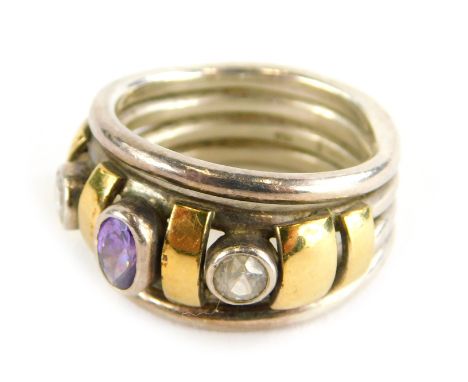 A dress ring, set with oval cut amethyst and two round brilliant cut diamonds, with yellow gold coloured breaks, on four band