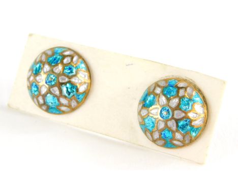 A pair of silver gilt and enamel earrings, each with blue and white enamel, with screw on backs. 