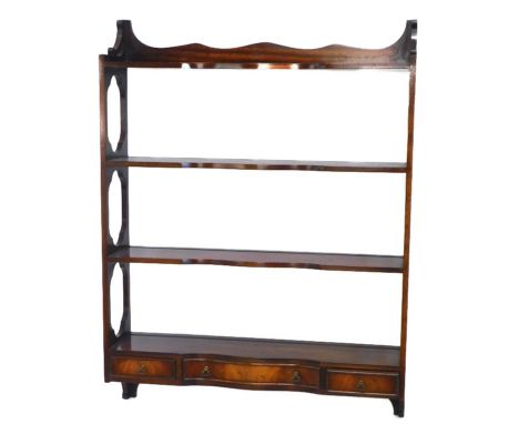 A mahogany wall shelf in George III style, with four shaped shelves, pierced end supports and three drawers, 91cm high, 69cm 