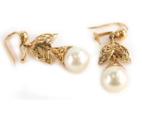 A pair of drop earrings, each with natural pearl drop, in a pierced wirework framing, yellow metal, unmarked, 6.1g all in.
