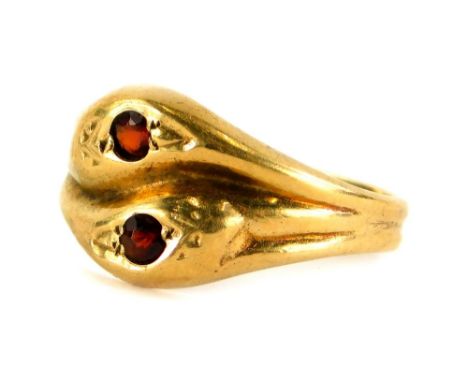 A Victorian 9ct gold dress ring, of two twist design, with two snake type heads, set with garnet stone, on two pleated band, 