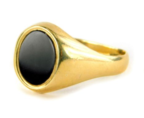 A 9ct gold gents signet ring, with oval onyx set panel, on a misshapen band, ring size X½, 5.4g all in.