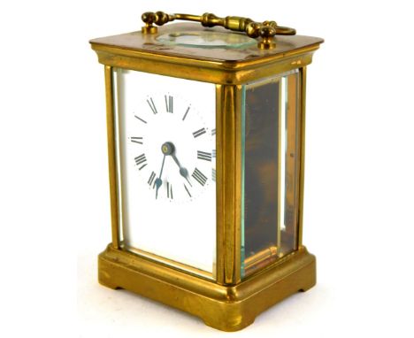 A 20thC brass carriage timepiece, the white enamel dial with black Roman numerals, 14cm high overall.