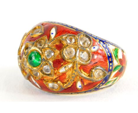 An Indian enamel and gem set ring, the ring set with central cabochon green emerald, in a floral cluster set with various old
