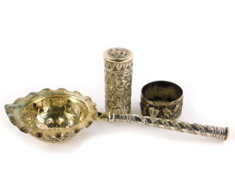 Three items of Eastern silver coloured metal, to include a sifter spoon with handle, napkin ring, and a cylindrical box and c