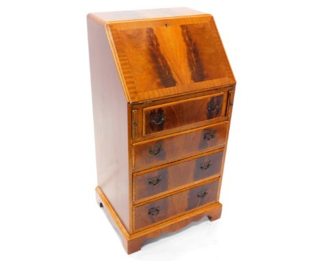 A narrow figured mahogany bureau, the fall enclosing a fitted interior, above four drawers with brass handles on bracket feet