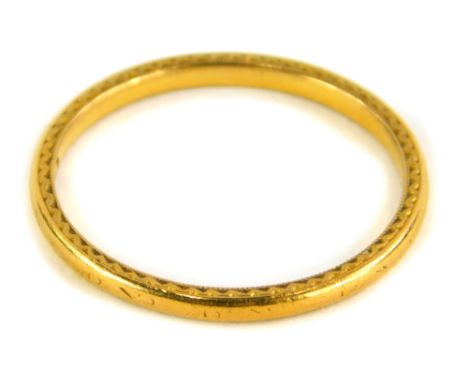 A 22ct gold thin wedding band, with rubbed etched decoration, Birmingham, ring size S, 2.6g.