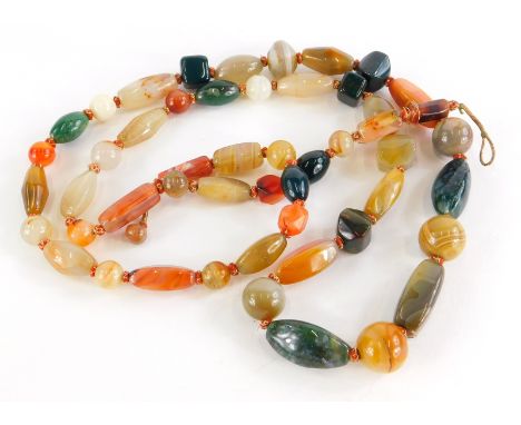 A hardstone necklace, set with various coloured agate and jade beads, of varying sizes and shaped, on a gold and red thread s