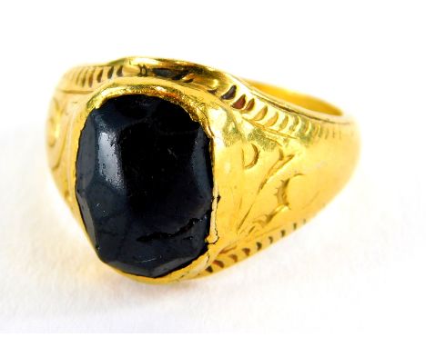 A garnet set signet ring, the setting of hammered design with scroll design shoulders and etched shoulders, yellow metal, unm