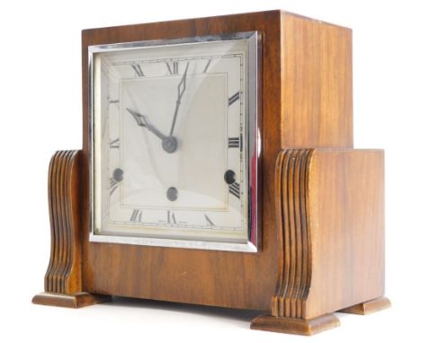 A walnut Art Deco mantel clock, with chrome plated bezel and Westminster chime, 26cm wide.