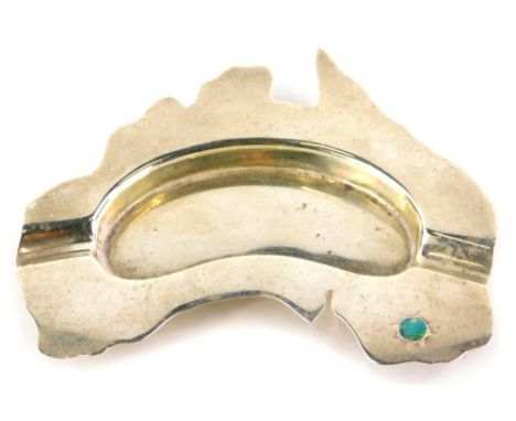 A novelty white metal ashtray, inset with an opal, possibly moulded in the shape of Australia, stamped to underside Prouds, 1