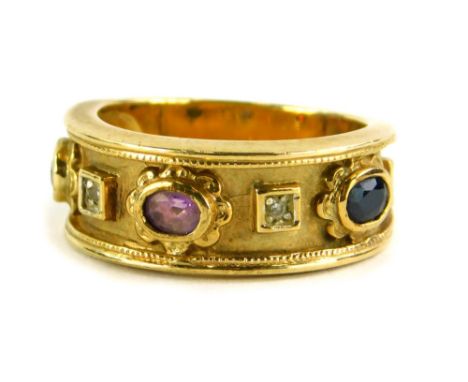 A Brooks and Bentley amethyst and diamond 9ct gold dress ring, of Eastern design with central amethyst, a sapphire and a ruby