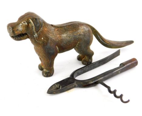 A cast iron nutcracker, modelled in the form of a dog, a set of clippers with cork screw attachment, possibly horse related. 
