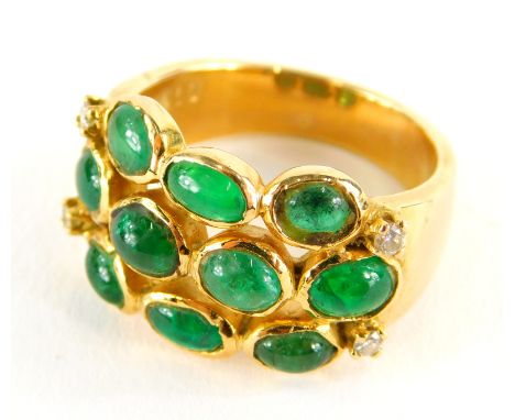 An emerald and diamond set dress ring, with three row design of cabachon emeralds, with four tiny diamonds, yellow metal, mar