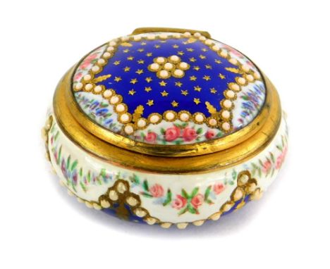 A continental enamel circular pill box, decorated with flowers, stars, stylised pearls picked out in gilt with gilt metal mou