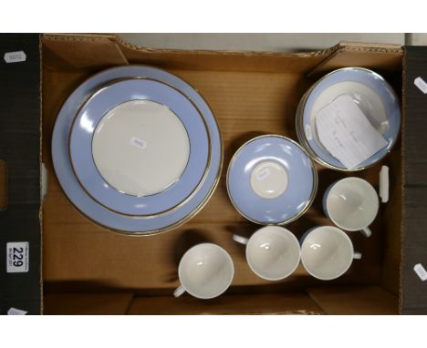 A collection of Royal Doulton dinnerware decorated in light blue with gild to include dinner plates, side plates, cups, sauce