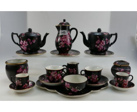 A collection of Carlton Ware, tea ware, Peach Blossom items on black ground to include: cups, saucers, tea and coffee pots, p
