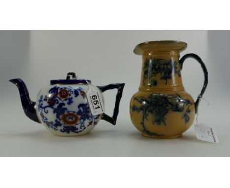 Royal Doulton Burslem teapot decorated in the Nankin design, height 13cm and Burslem jug in the May design. (2)