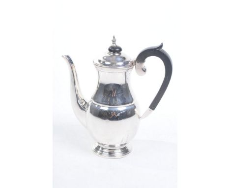 A hallmarked silver coffee pot 
Of cylindrical bulbous form, raised on a stepped plinth base, made by Cooper Brothers & Sons 