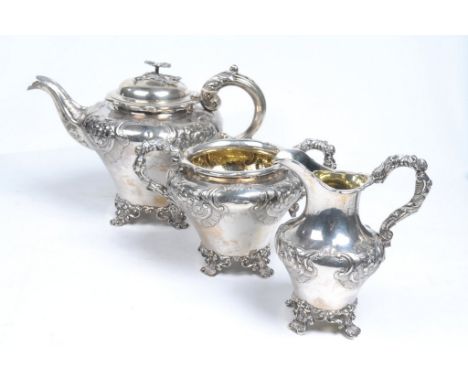 A Victorian three-piece silver tea service
Comprising teapot, milk jug and twin handled sugar bowl, chased and engraved with 