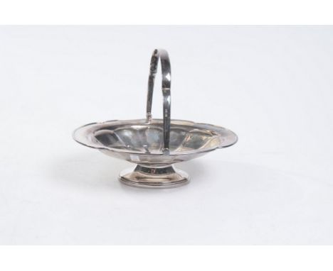 A George V silver pedestal fruit basket 
the scalloped bowl wit lobed interior and swing handle, raised on a pedestal stem, 7