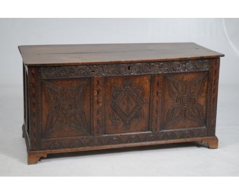 A 17th Century carved oak and marquetry three-panel blanket chest
The rectangular two-plank top above an interlaced dragon ca