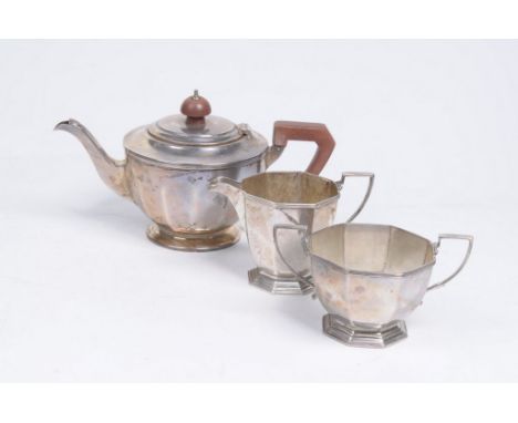 A George V silver three piece matched tea service
Comprising a teapot with wooden handle and finial, 12cm high, 14.4oz, toget