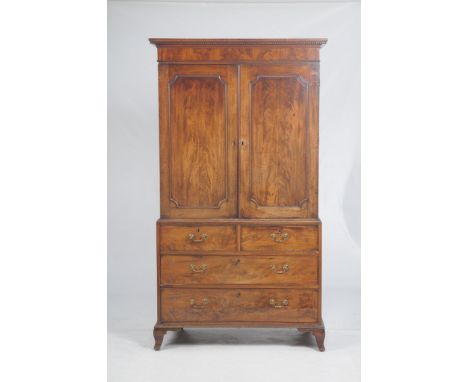 An early 19th Century mahogany gentleman's wardrobe
With a dentil cornice above a plain frieze and a pair of panelled cupboar