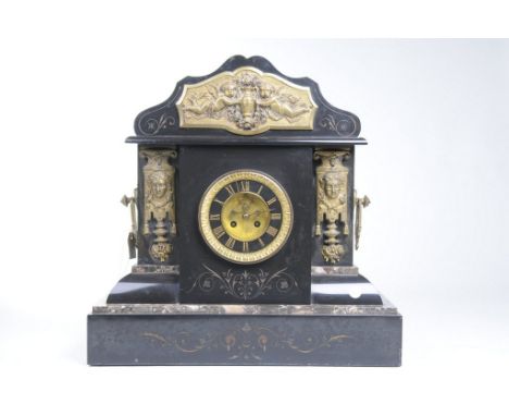 A Victorian slate noir and brass mounted mantel clock
With an eleven centimetre dial with Roman numerals, the two train movem