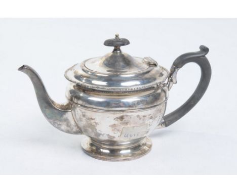 A George V silver teapot
Of pedestal form, flanked by swept spout and ebonised handle and finial, 15cm high, Mappin & Webb, B