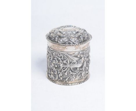 A Victorian silver dressing table lidded pot
The cylindrical form pot with domed cover, beautifully chased with birds amidst 