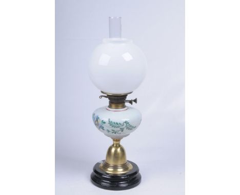 A Victorian opaque glass and brass paraffin lamp
With a circular treacle glazed plinth, bell shape foot rising to an opaque p