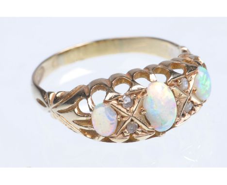 An Edwardian 18ct yellow gold opal and diamond ring 
Featuring three graduated elliptical opals and five diamond chips, total