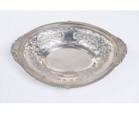 An Edward VII pierced silver fruit or pastry basket
Of oval form with rope work borders and flowerhead motifs, the reticulate