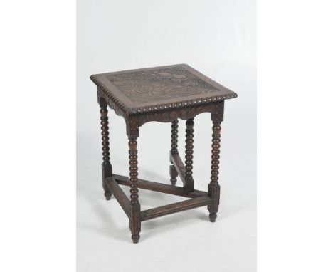 An 19th Century carved oak corner table
The hinged rectangular top carved with fruit, leaves and flowers, gadroon border rais